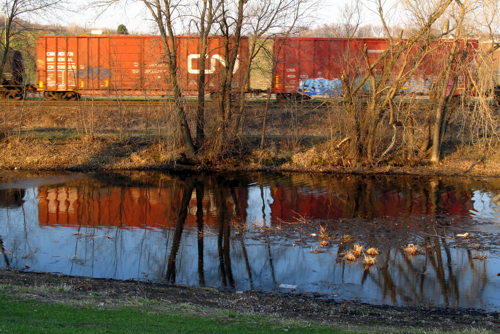 Reflection of a train in water as it passes by.