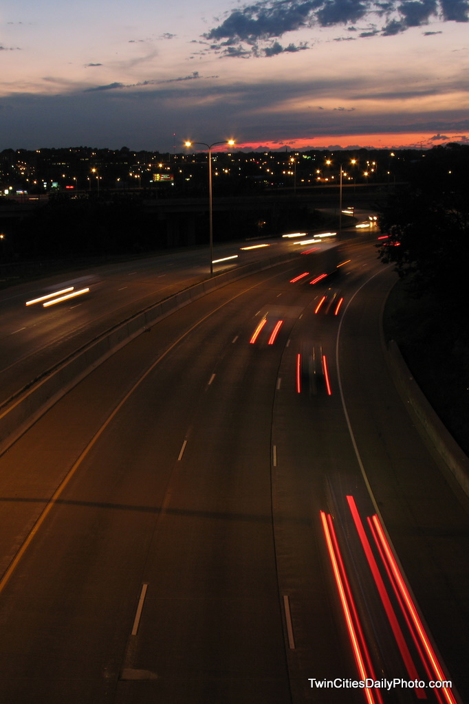 On the overpass of Interstate 94, near Mounds Boulevard in St Paul, traffic whizzes under my camera lens at light speed.
