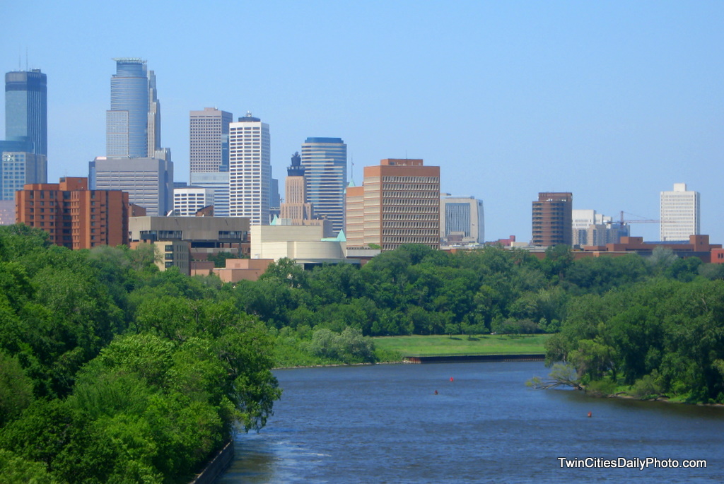 The skyline of downtown Minneapolis on a bright sunny day while crossing the Minnesota River.