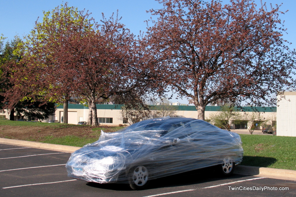 A practical joke was played on a co-worker, they jokers shrink wrapped a vehicle with plastic wrap.