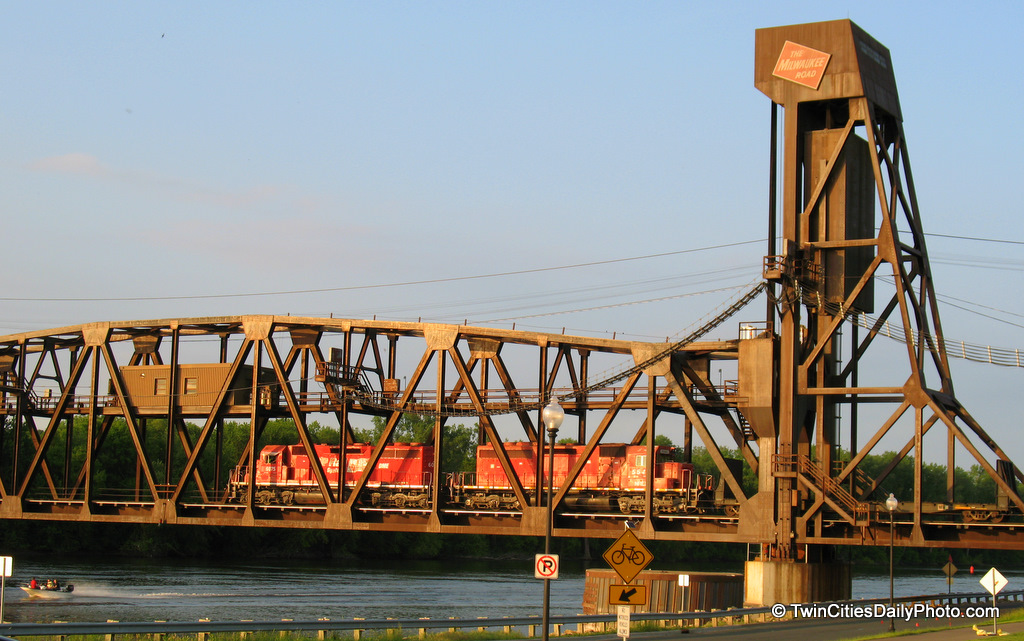 Two trains crossing the Mississippi River on the Milwaukee road bridge.